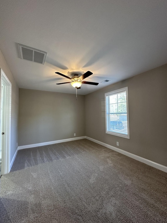 spare room featuring carpet floors and ceiling fan