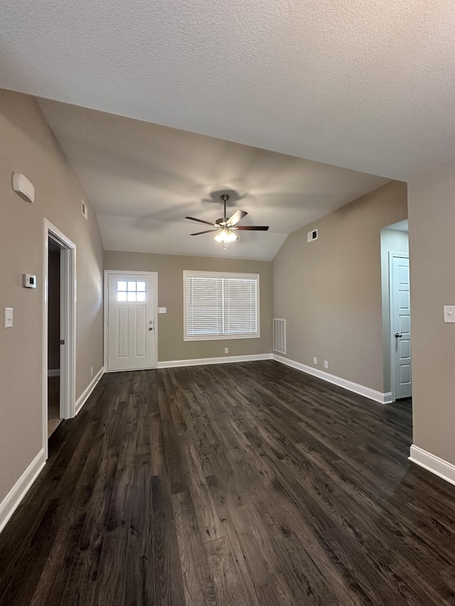 unfurnished living room featuring ceiling fan, dark hardwood / wood-style flooring, and vaulted ceiling