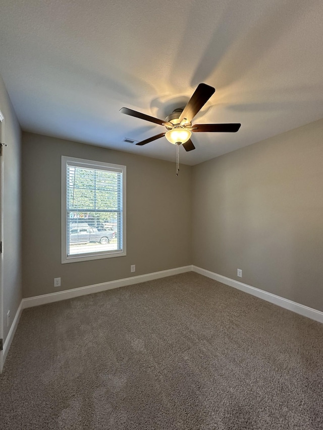 unfurnished room with ceiling fan and carpet flooring