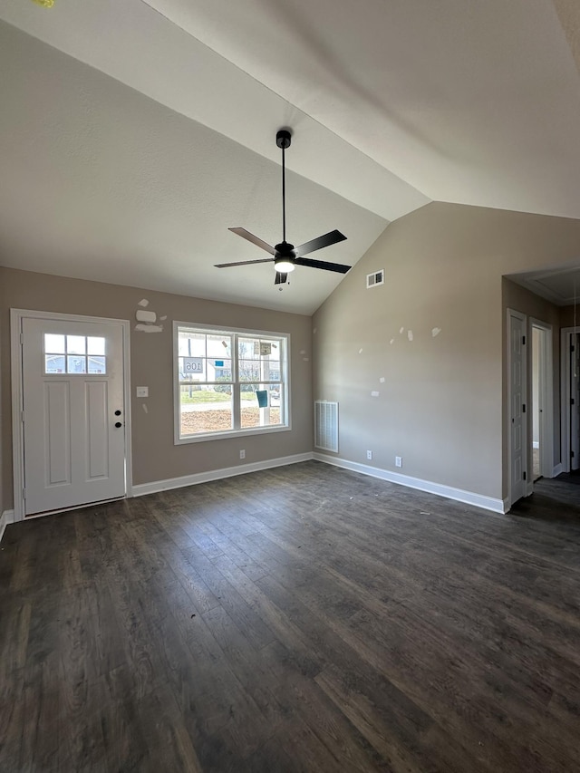 unfurnished living room featuring dark wood-style flooring, lofted ceiling, visible vents, ceiling fan, and baseboards