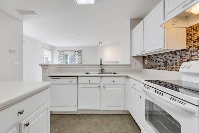 kitchen with white cabinetry, sink, extractor fan, white appliances, and decorative backsplash