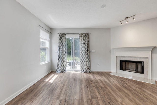 unfurnished living room featuring a textured ceiling, wood-type flooring, and a fireplace