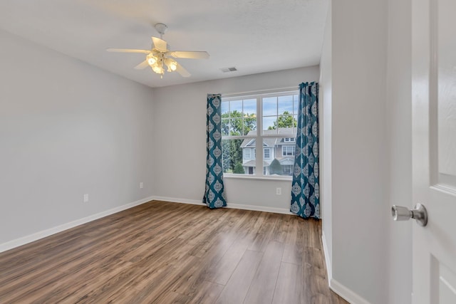 empty room featuring ceiling fan and hardwood / wood-style floors