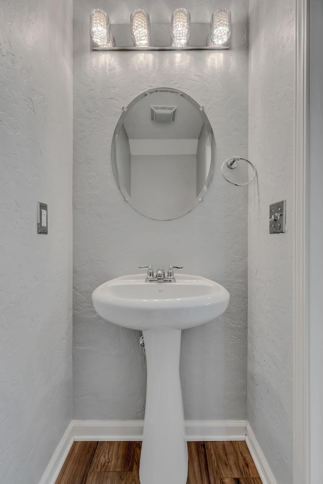 bathroom with sink and hardwood / wood-style flooring