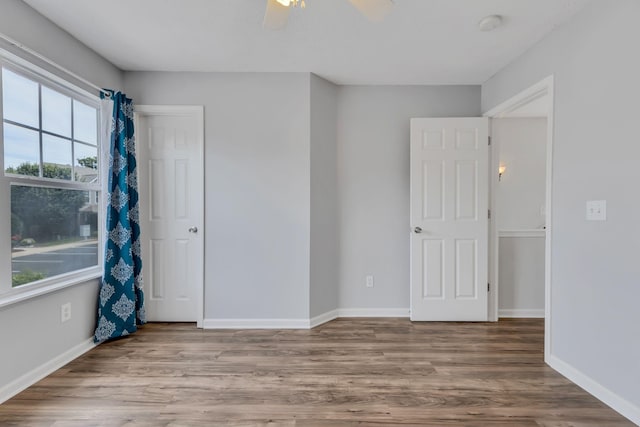 unfurnished room featuring hardwood / wood-style floors and ceiling fan