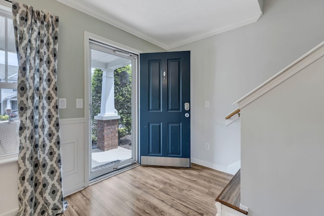 foyer featuring light hardwood / wood-style flooring and ornamental molding