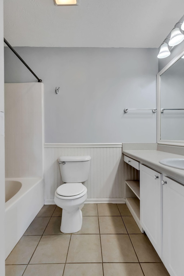 full bathroom featuring toilet, shower / bathing tub combination, vanity, and tile patterned floors