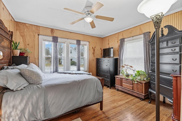 bedroom featuring multiple windows, ceiling fan, and crown molding