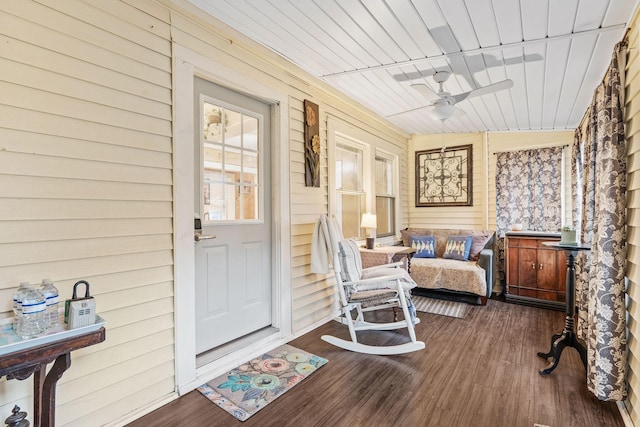 sunroom / solarium featuring ceiling fan, wooden ceiling, and lofted ceiling