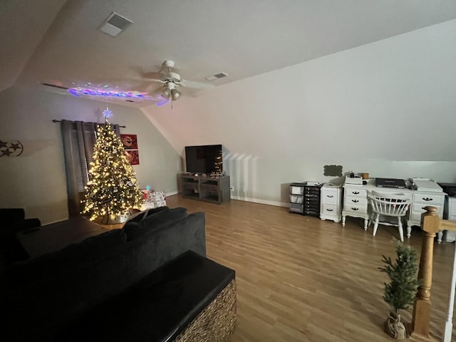 living room with hardwood / wood-style floors, vaulted ceiling, and ceiling fan