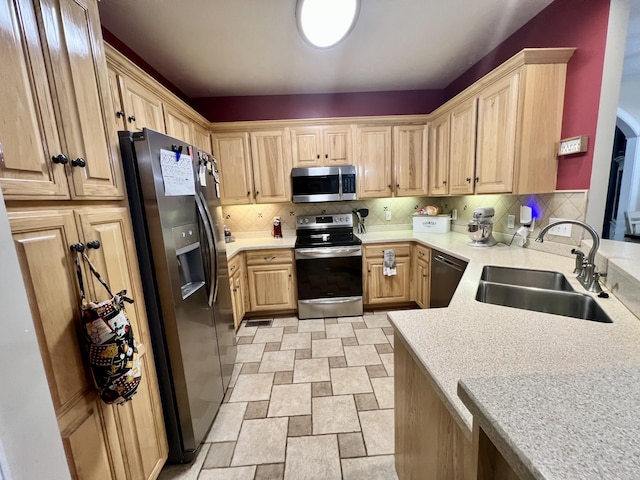 kitchen featuring backsplash, sink, light brown cabinets, and appliances with stainless steel finishes