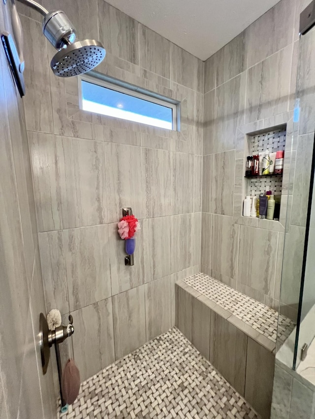 bathroom with a tile shower