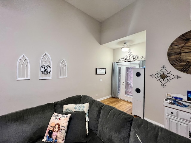 living room with lofted ceiling and light wood-type flooring