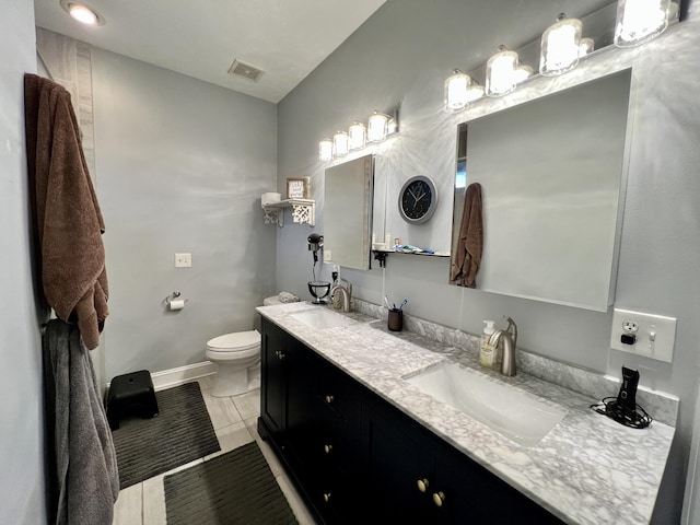 bathroom with tile patterned floors, vanity, and toilet