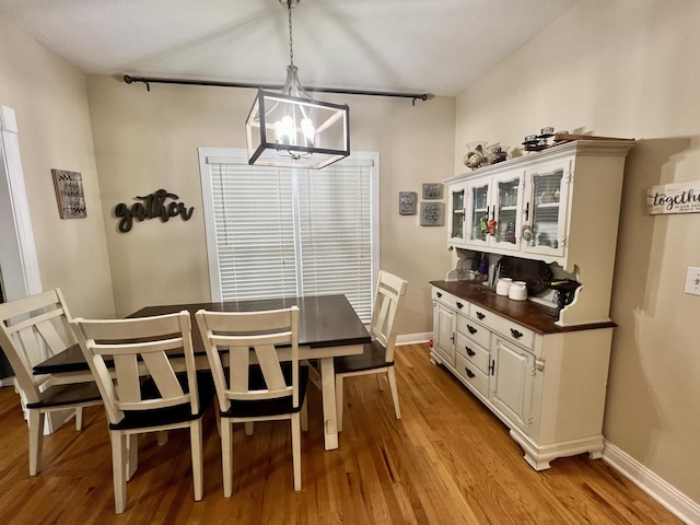 dining area featuring a chandelier and light hardwood / wood-style flooring