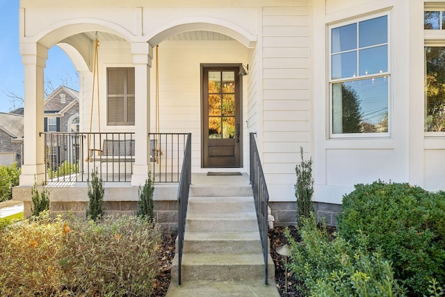 view of exterior entry with a porch