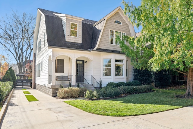 view of front of property with a front yard and a porch