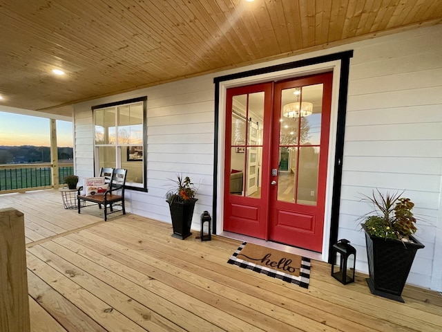 exterior entry at dusk with a porch and french doors