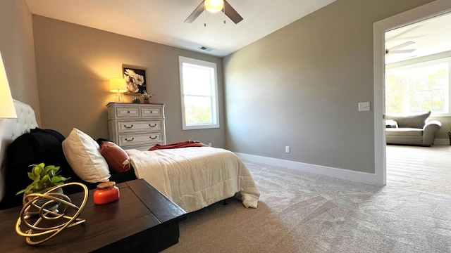 bedroom featuring multiple windows, ceiling fan, light colored carpet, and vaulted ceiling