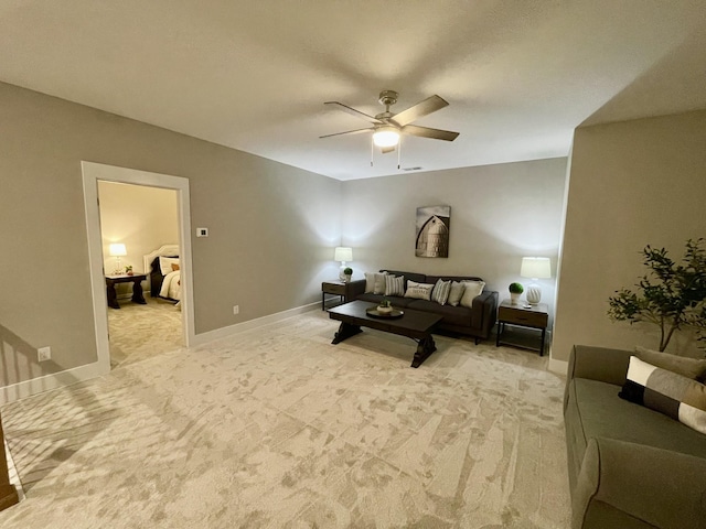 carpeted living room featuring ceiling fan