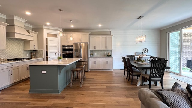 kitchen with pendant lighting, stainless steel appliances, and plenty of natural light