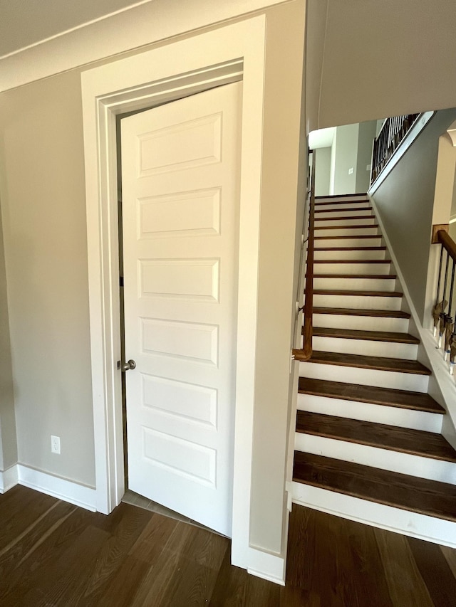 staircase with hardwood / wood-style floors