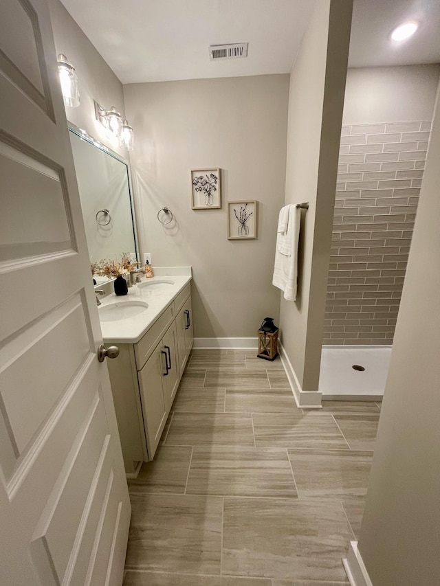 bathroom with vanity and a shower