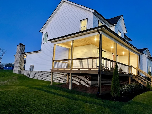 rear view of house featuring a yard