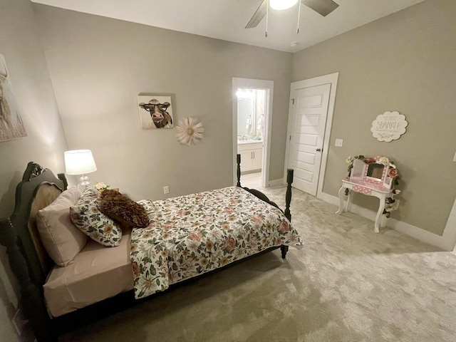 carpeted bedroom featuring ceiling fan and ensuite bath