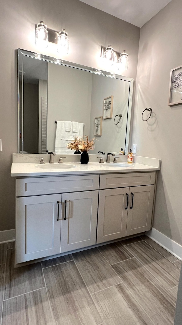 bathroom featuring hardwood / wood-style flooring and vanity