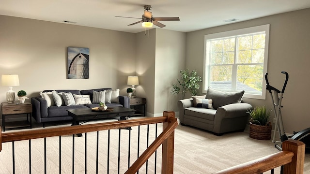 carpeted living room featuring ceiling fan