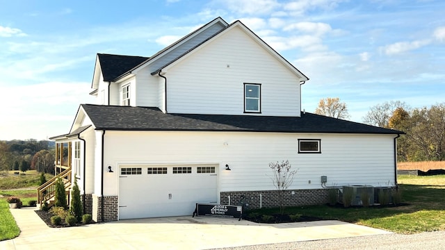 view of property exterior featuring central AC unit and a garage