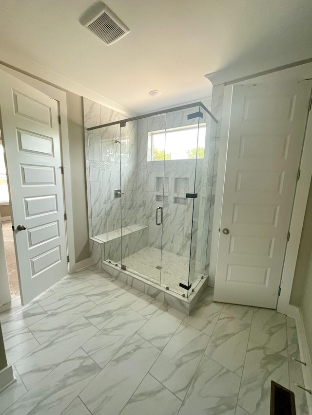 bathroom with a shower with door