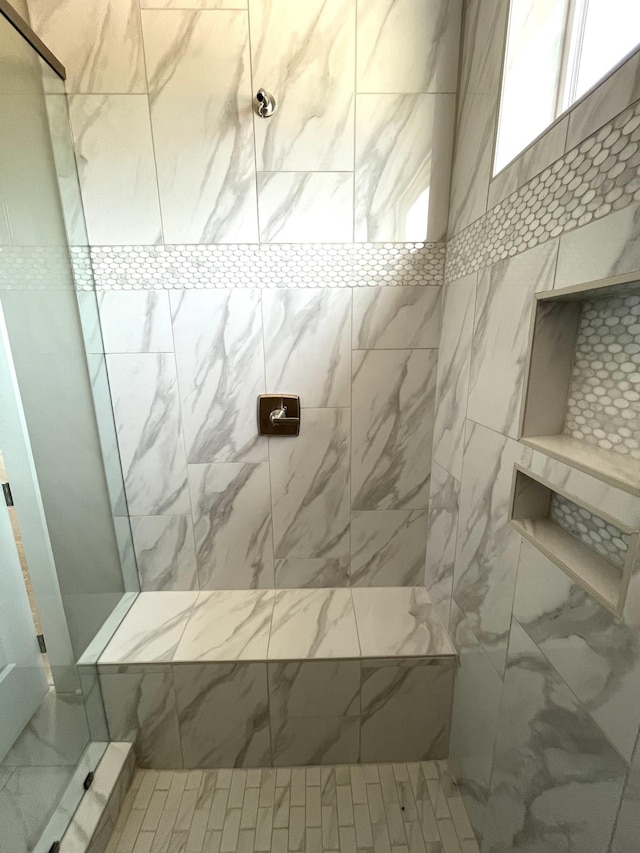 bathroom featuring a tile shower