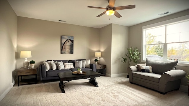 carpeted living room with ceiling fan