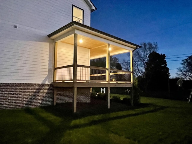 view of side of home with a yard