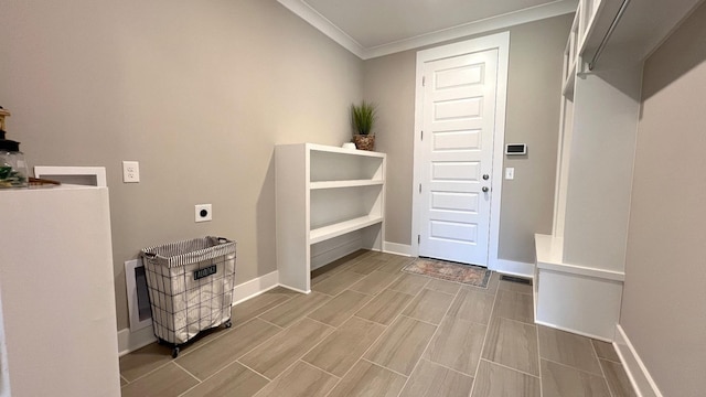 interior space featuring hookup for an electric dryer and crown molding