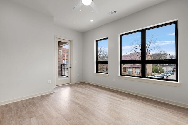 unfurnished room with ceiling fan and light hardwood / wood-style flooring