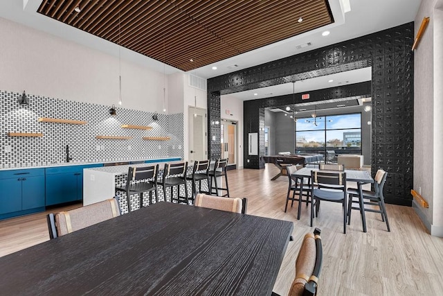 dining space featuring light hardwood / wood-style floors and sink