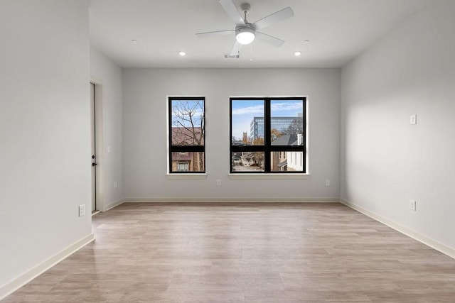 empty room featuring ceiling fan and light hardwood / wood-style flooring