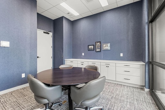 dining space featuring a drop ceiling