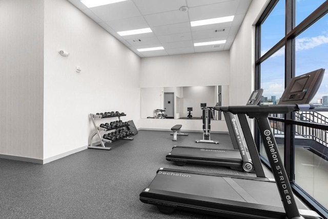 gym with a paneled ceiling