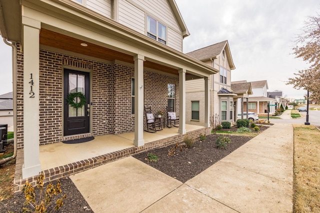 entrance to property featuring a porch