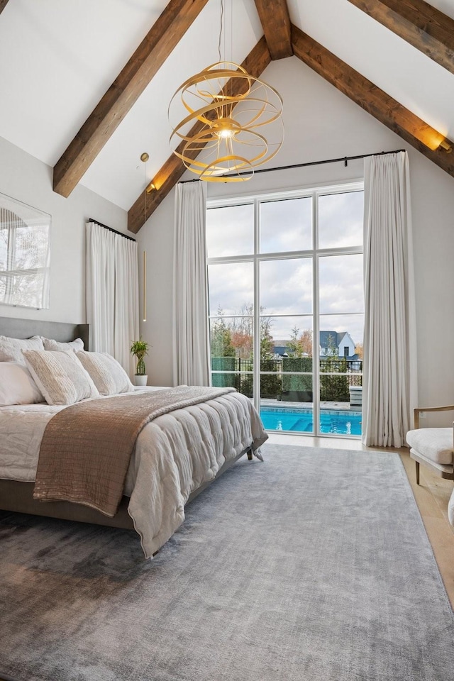 bedroom featuring lofted ceiling with beams, access to exterior, and multiple windows