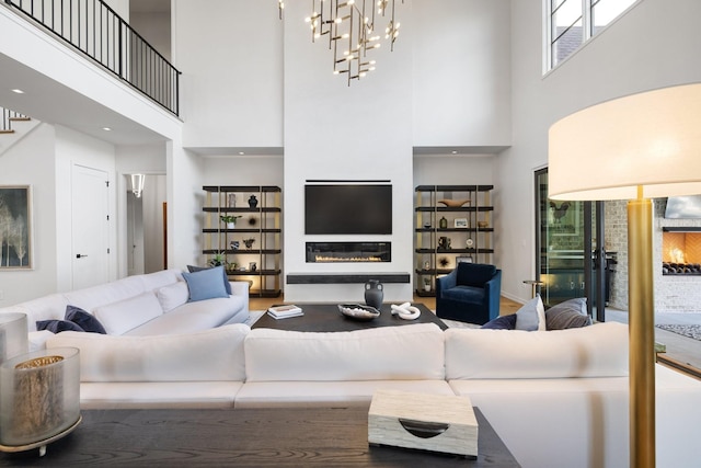 living room with a towering ceiling and a chandelier