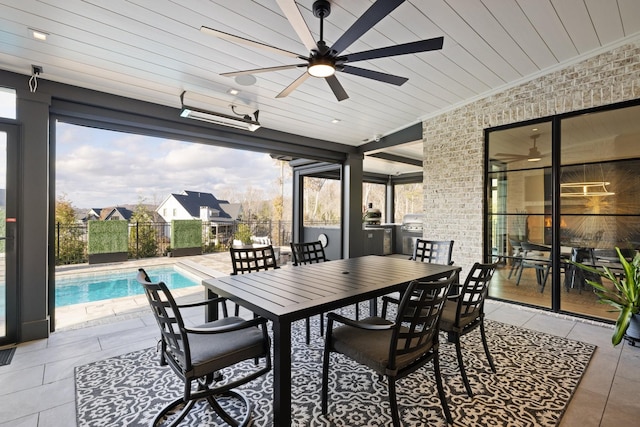 exterior space featuring ceiling fan, a fenced in pool, and grilling area