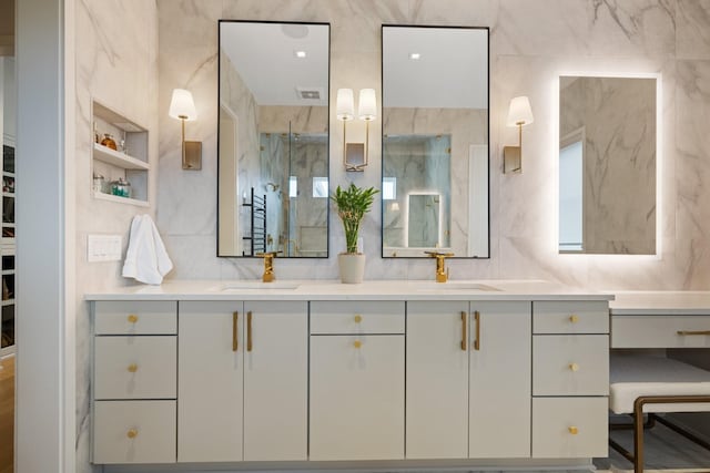 bathroom featuring vanity, a shower with shower door, and tile walls