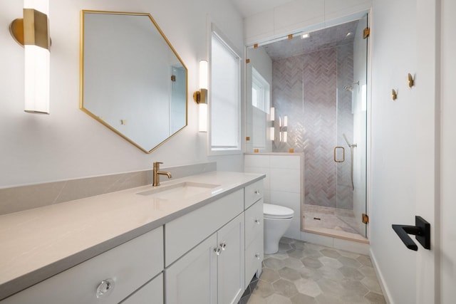 bathroom with tile patterned flooring, vanity, toilet, and walk in shower