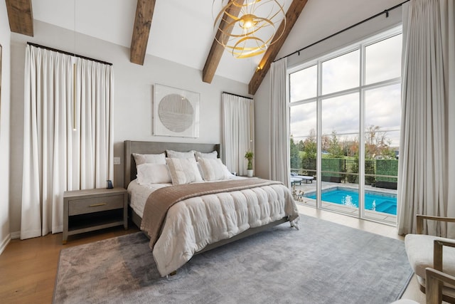 bedroom with hardwood / wood-style floors, vaulted ceiling with beams, and access to exterior