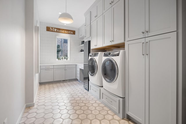 laundry room featuring cabinets and separate washer and dryer